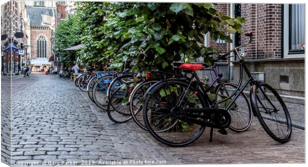 Multiple bicycles parks on a Dutch street Canvas Print by Gary Parker