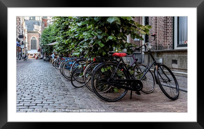 Multiple bicycles parks on a Dutch street Framed Mounted Print by Gary Parker