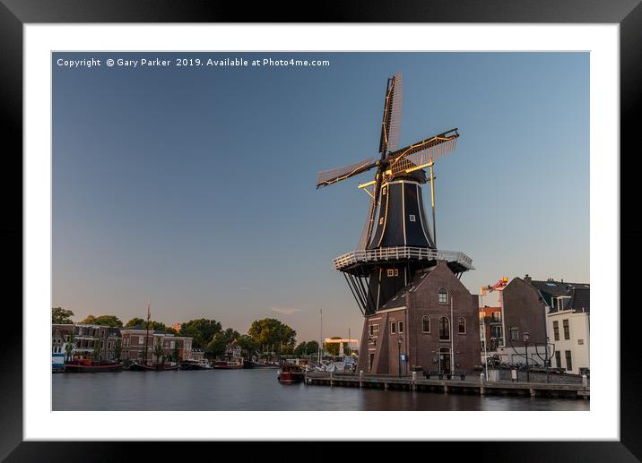 Dutch windmill, in the town of Haarlem, at sunset. Framed Mounted Print by Gary Parker