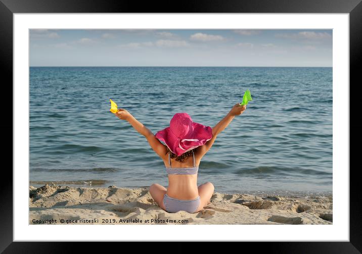 happy little girl with hat looking at the sea Framed Mounted Print by goce risteski