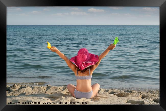 happy little girl with hat looking at the sea Framed Print by goce risteski