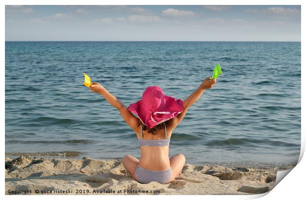 happy little girl with hat looking at the sea Print by goce risteski