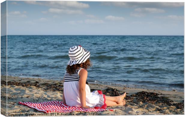 little girl sitting on beach Canvas Print by goce risteski