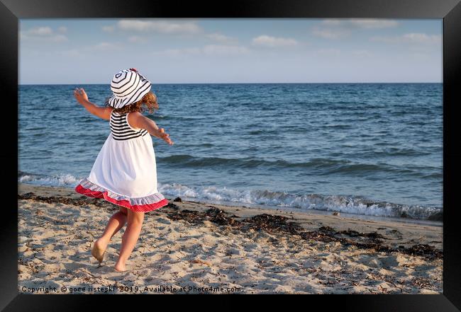 happy little girl running on beach Framed Print by goce risteski