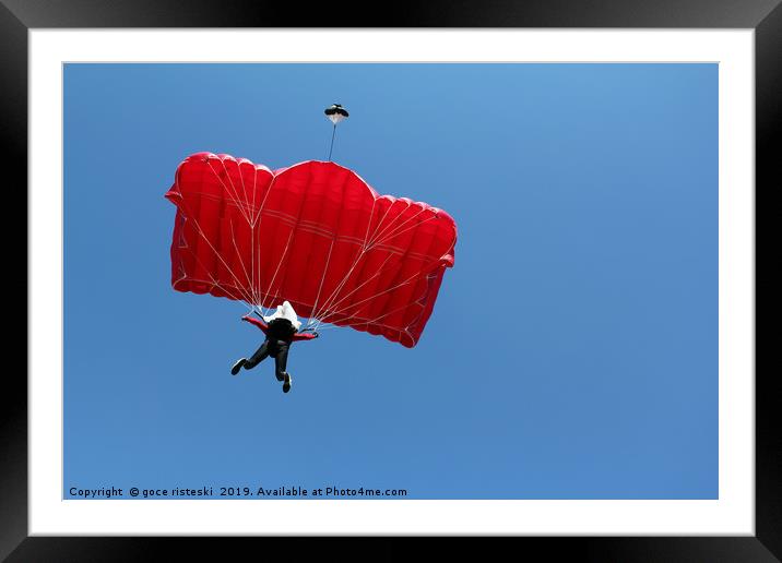 parachutist with red parachute on blue sky Framed Mounted Print by goce risteski