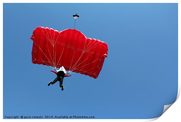 parachutist with red parachute on blue sky Print by goce risteski