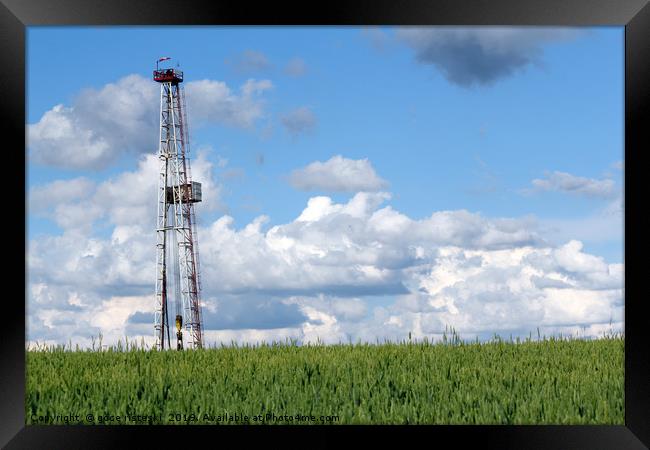 landscape with oil drilling rig blue sky and green Framed Print by goce risteski