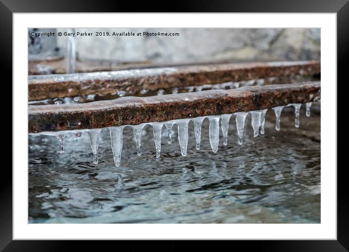 Icicles formed above a traditional water tank Framed Mounted Print by Gary Parker