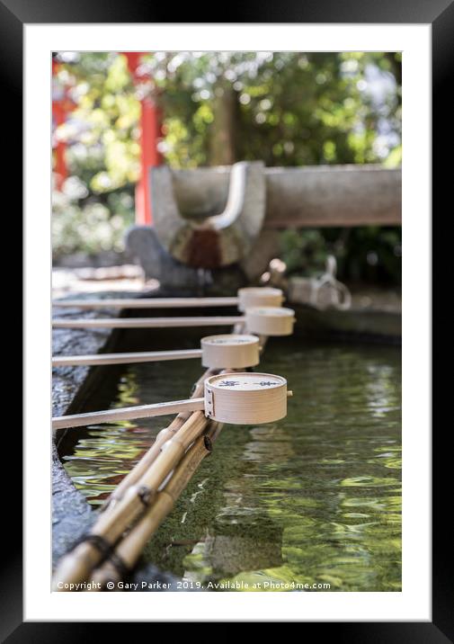 Row of ceremonial water cups at Japanese temple Framed Mounted Print by Gary Parker
