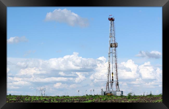 land oil drilling rig on field landscape Framed Print by goce risteski
