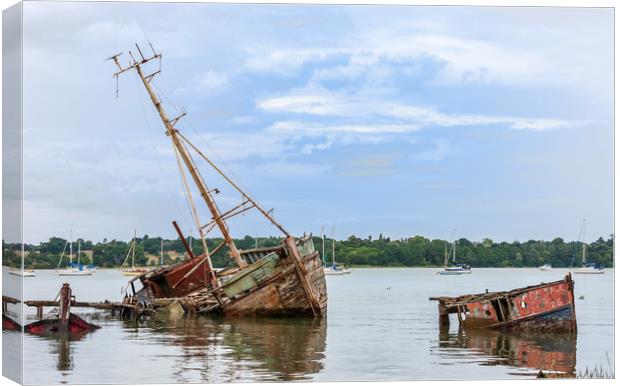 Decaying Fleet Surrenders to Tides Canvas Print by Kevin Snelling