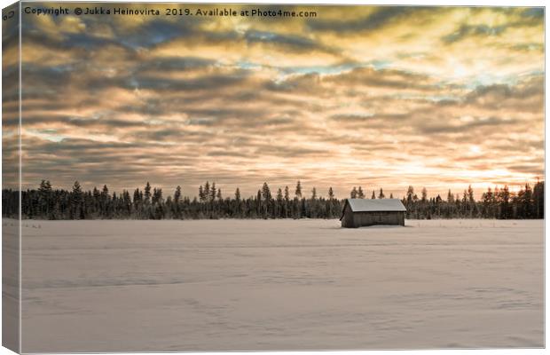 Sunset Over The Snow Covered Fields Canvas Print by Jukka Heinovirta