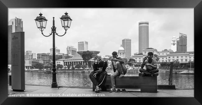 Three men sat on a bench on Boat Quay, Singapore  Framed Print by Kevin Hellon