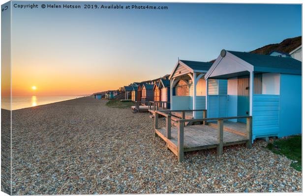 Sunset over Beach Huts Canvas Print by Helen Hotson