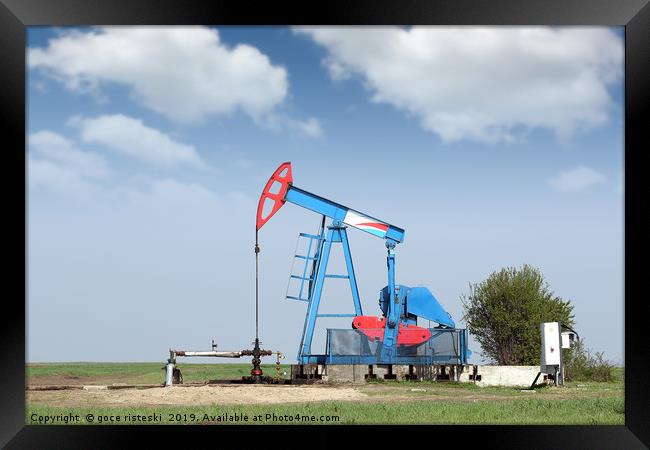 oil pump jack on field Framed Print by goce risteski