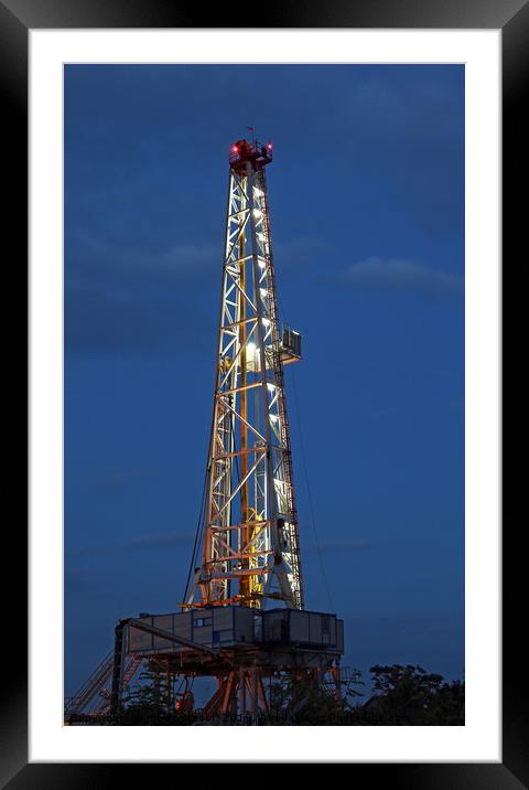 illuminated oil drilling rig on oilfield Framed Mounted Print by goce risteski