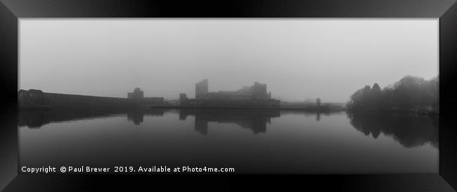 Caerphilly Castle on a misty gloomy day Framed Print by Paul Brewer