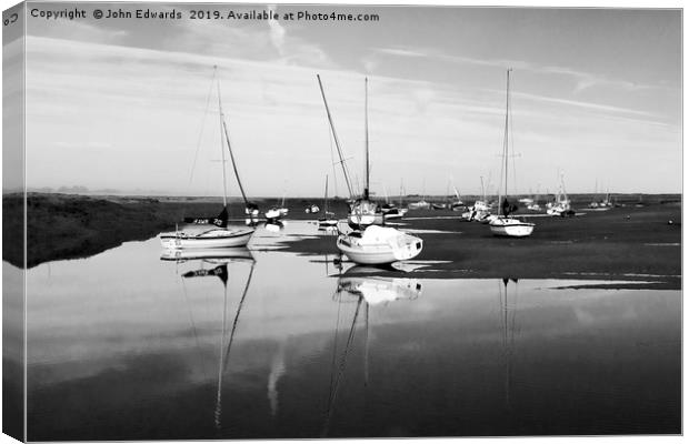 Reflections at Brancaster Staithe Canvas Print by John Edwards