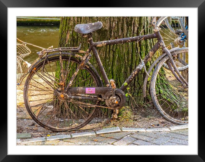 Abandoned bike on an Amsterdam canal-side Framed Mounted Print by Paul Nicholas