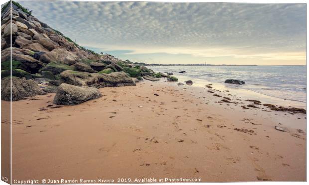 Small wet sand beach surrounded by steep rocks cli Canvas Print by Juan Ramón Ramos Rivero
