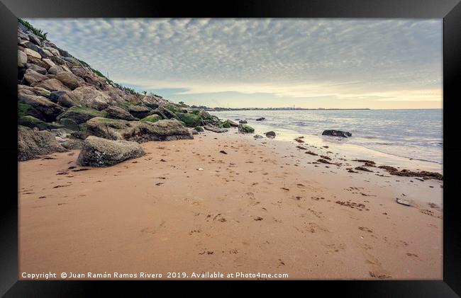 Small wet sand beach surrounded by steep rocks cli Framed Print by Juan Ramón Ramos Rivero