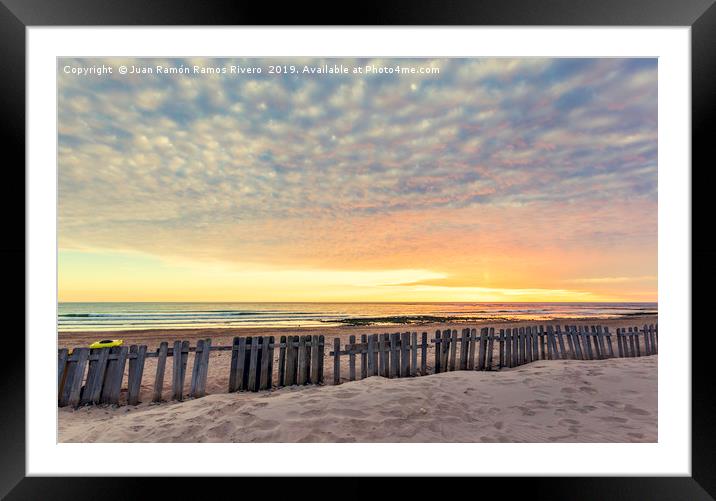Fence on sand beach at sunset in Chipiona Framed Mounted Print by Juan Ramón Ramos Rivero