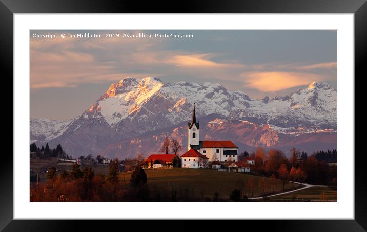 Prezganje church with snowy Kamnik Alps in the bac Framed Mounted Print by Ian Middleton