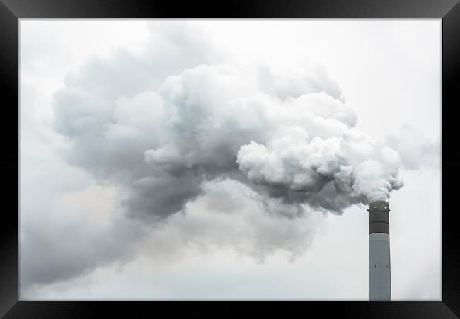 Tall chimney exhausting pollution in the air Framed Print by Ankor Light