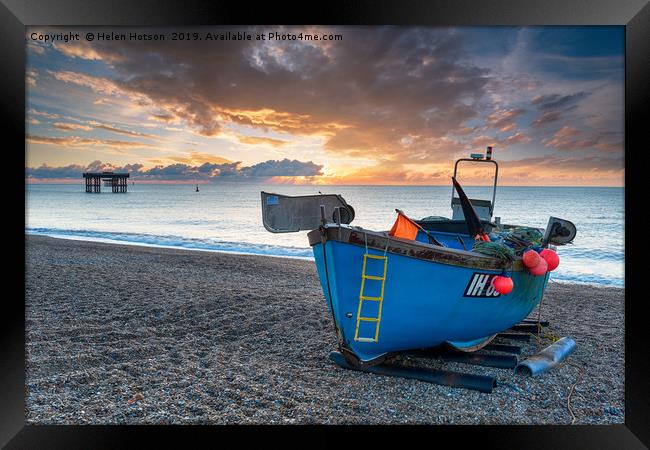 Dramatic sunrise sky over a fishing boat on the be Framed Print by Helen Hotson