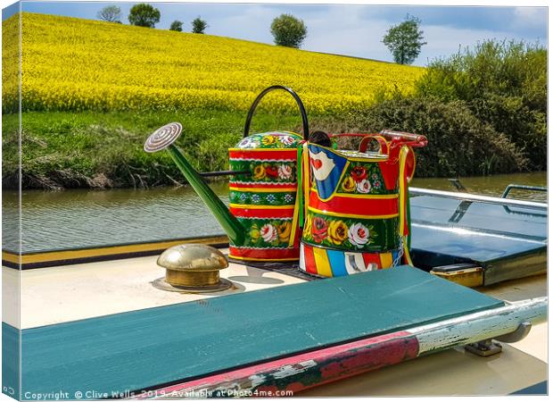 Watering cans on a narrow boat. Canvas Print by Clive Wells