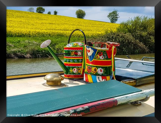 Watering cans on a narrow boat. Framed Print by Clive Wells