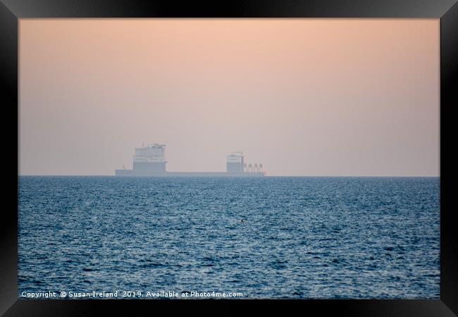 Boskalis ship in the horizon of a sunset Framed Print by Susan Ireland