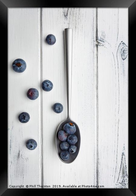 blueberries and a silver spoon on distressed white Framed Print by Phill Thornton