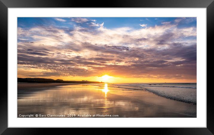 A Bamburgh sunset Framed Mounted Print by Gary Clarricoates