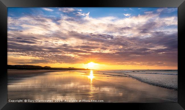 A Bamburgh sunset Framed Print by Gary Clarricoates