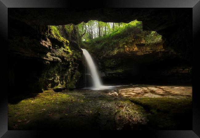 A cave with a waterfall Framed Print by Leighton Collins
