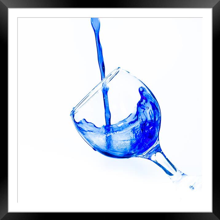 Pouring water into a wine glass Framed Mounted Print by David Strange