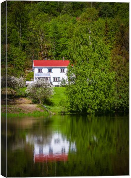 Reflections of a white house on a small lake in Op Canvas Print by Hamperium Photography