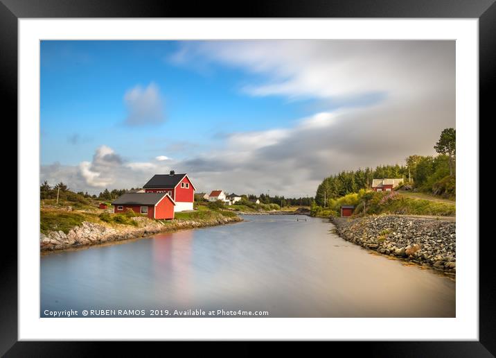 A river and red painted houses. Framed Mounted Print by RUBEN RAMOS