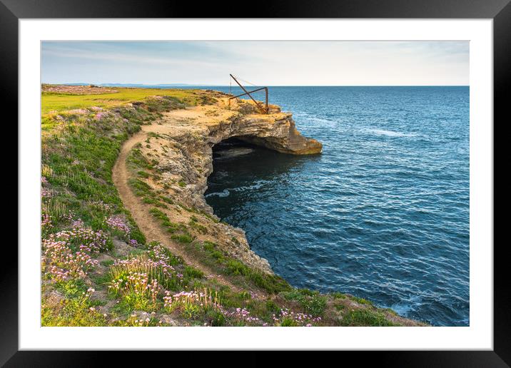 Stone quarry crane above sea cave Framed Mounted Print by Andrew Michael