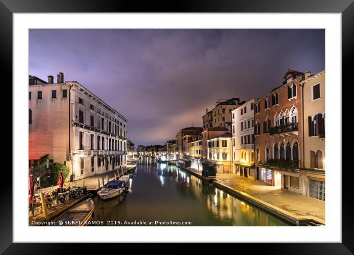 A canal water street with boats in Venice. Framed Mounted Print by RUBEN RAMOS