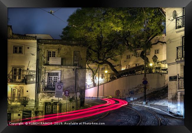 The Rua do Salvador street and light tails at nigh Framed Print by RUBEN RAMOS