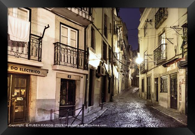 A narrow stone street empty in Lisbon. Framed Print by RUBEN RAMOS