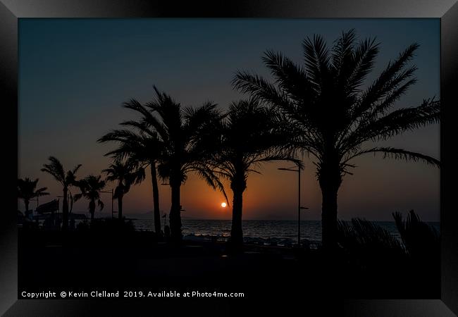 Sun setting in Crete Framed Print by Kevin Clelland