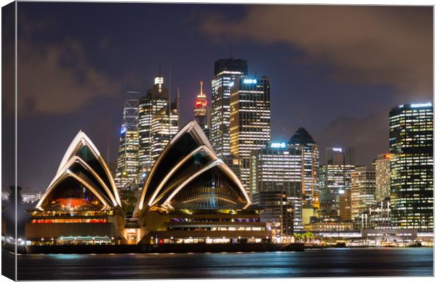 Sydney Opera House and skyline after dark.  Canvas Print by Andrew Michael