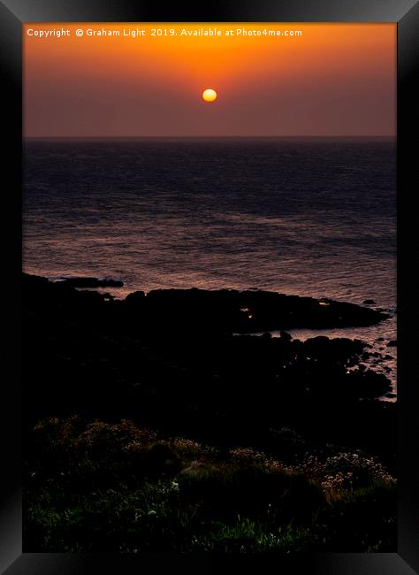 Setting sun over Cape Cornwall Framed Print by Graham Light