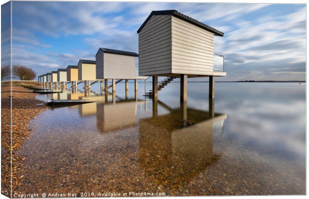 Reflections at Osea Beach Huts. Canvas Print by Andrew Ray