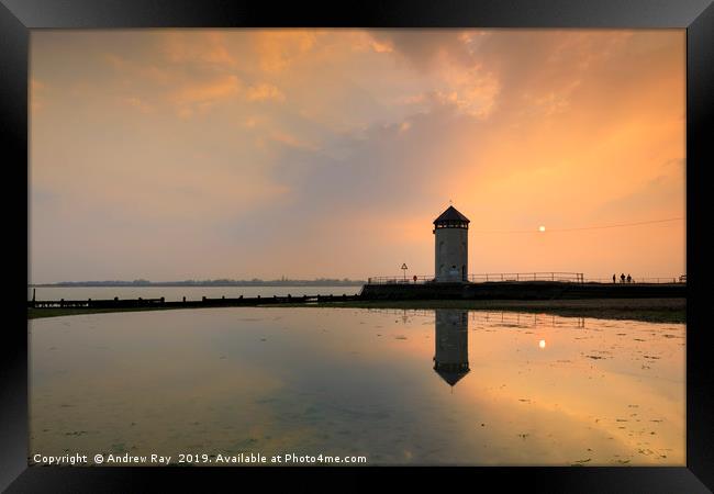 The setting sun behind Batemans Tower (Brightlings Framed Print by Andrew Ray