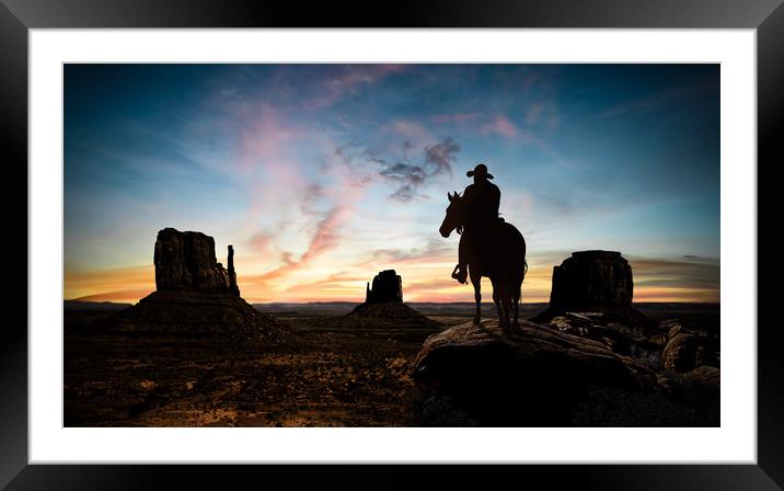 Silhouette of a cowboy at sunset Framed Mounted Print by Guido Parmiggiani