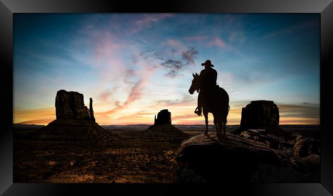 Silhouette of a cowboy at sunset Framed Print by Guido Parmiggiani